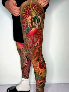 a man with tattoos on his legs and leggings