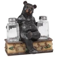 a statue of a bear sitting on top of two jars