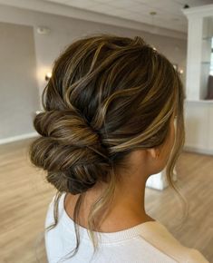 a woman with her hair in a low bun