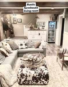 a living room filled with furniture and a cow print rug on top of a wooden floor