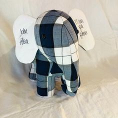 an elephant stuffed animal with a name tag on it's ear and plaid pattern