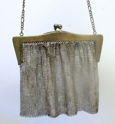 Rare Antique STERLING Silver MESH BAG Purse Signed JEB James E Blake   Offering antique STERLING SILVER MESH Purse Bag. Marled on inside-- both sides--Sterling  JEB ( James E. Blake -- Attlesboro Mass).    Very fine chain link handle.  Approx  Total l with Handle-- 13"   Across top frame 5"   Closures to bottom of back 5 1/2" Opens easily and closes securely.  Monogram on on side of top.  Handle sturdy and secure. One link on very  top -- to be reattached-- not distracting. Rare to find signed. Antique Rectangular Bags For Vintage Fashion, Vintage Silver Rectangular Bag, Vintage Silver Rectangular Shoulder Bag, Vintage Silver Handheld Bag, Vintage Silver Bag For Everyday Use, Retro Silver Rectangular Bag, Retro Silver Rectangular Bags, Mesh Bags, Silver Coin