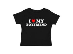 I Love My Boyfriend Baby Tee Graphic t-shirt with text and red heart Available in sizes small, medium, and large Measurements (in inches): Small- Width: 16 Length: 19.5 Medium- Width: 18 Length: 23 Large- Width: 19 Length: 25 Care Instructions: * Do not dry clean * Wash and dry inside out * Hang dry (preferred) or machine dry on a delicate setting * Use cold water * Use mild detergent * Do not bleach I Heart My Bf Shirt, I ❤️ Shirts, I Love My Boyfriend Shirt, I Heart My Boyfriend, Girlfriend Shirt, Bebe T Shirt, I Love My Boyfriend, Girlfriend Shirts, Love My Boyfriend