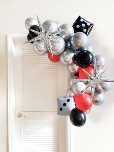 a door decorated with black, white and red balloons