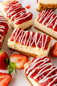 strawberry shortcakes with white icing and strawberries on a plate next to each other