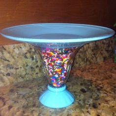 there is a bowl with sprinkles in it on the counter