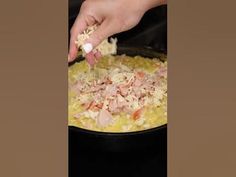 someone is adding ingredients to a dish in a pan