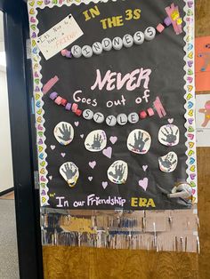 a bulletin board that has been decorated with handprints and other writing on it