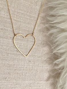 "Open Heart Necklace:  * Beautiful premium 14 karat gold-filled or sterling silver heart is hand-shaped and forged lending to the artisan quality that we love. * Choose your pendant size Regular heart: approximately 1\" Large heart: approximately 1.375\"W x 1.5\"H * Dainty and light Rolo chain gives this necklace a modern, smooth look that is so pretty. It's a perfect match for the elegant open line style heart pendant. * Comes in 17\" length chain with an option to add a 2\" extender chain. Ple