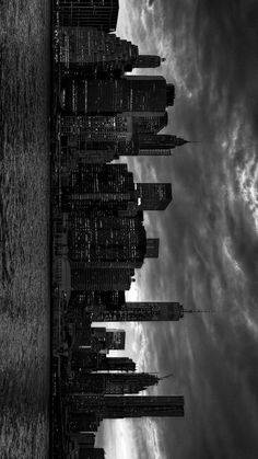 black and white photograph of the skyline of new york city with clouds in the background