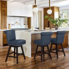 a kitchen with two stools and an island