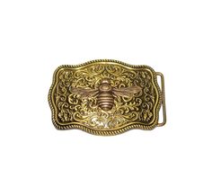 a brass belt buckle with a bee on it's side and ornate design in the center