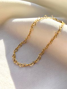 Delicate 14kt gold filled heart chain bracelet. The delicate and minimalist design of this link bracelet goes well with both casual and sophisticated looks. Wear it on its own or layered with other bracelets in our shop. Perfect for a gift! ✦ MATERIALS ✦ 14kt gold filled heart chain and lobster claw clasp. ✦ SIZING ✦ Available in 3mm width. ✦ PACKAGING ✦ All orders are packed in jewelry boxes/pouches with a brand logo, which makes it perfect for gifting. All packaging materials including mailers Trendy Gold Heart Bracelet With Adjustable Chain, Trendy Gold Heart Bracelet With Chain, Everyday Gold Double Heart Bracelet, Delicate Heart Bracelet For Valentine's Day, Gold Heart-shaped Chain Bracelets, Minimalist Heart-shaped Bracelet With Delicate Chain, Minimalist Heart Bracelet With Delicate Chain For Everyday, Minimalist Heart Bracelet With Delicate Chain, Dainty Delicate Chain Bracelets For Valentine's Day