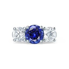 an oval blue sapphire and three stone diamond ring