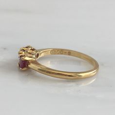 Details: Lovely Mid Century 18K yellow gold diamond and ruby ring, with two rubies and a diamond. Please ask all necessary questions prior to placing an order. Measurements: The size is 5 3/4 US and can be sized for a fee. Condition: The overall all condition of this ring is very good. Luxury Three Stone Ruby Ring, Luxury Marquise Cut Ruby Ring In Yellow Gold, Luxury Marquise Cut Yellow Gold Ruby Ring, Luxury Yellow Gold Ruby Ring With Marquise Cut, Luxury Yellow Gold Marquise Cut Ruby Ring, Classic Three Stone Ruby Ring With Diamonds, Gold Amethyst Ring With Brilliant Cut Diamond, Formal Oval Ruby Ring With Single Cut Diamonds, Gold Diamond Ring With Pink Sapphire For Wedding