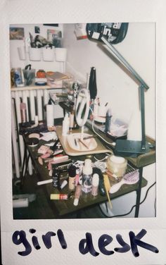 a desk with various items on it and the words girl desk written in blue ink