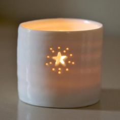 a white candle with gold stars on it