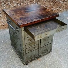 an old metal and wood desk with drawers