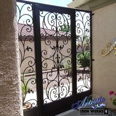 an iron screen door in front of a house