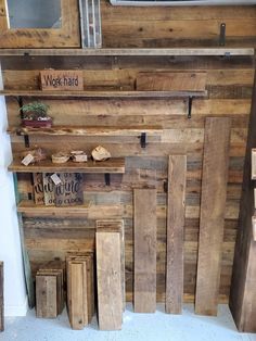 some wood planks are stacked on top of each other in front of a tv