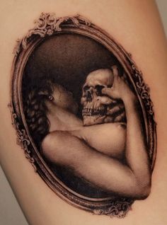 a woman's arm with a skull in the shape of a frame on it