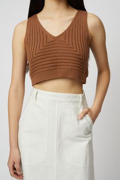 Cropped vest in our basketweave and rope yarn rib. Contrasting horizontal and vertical ribbing play subtly off the v neckline in this mid-weight cotton knit. Pair back to our Wide Leg Pant or Erin Skirt for sporty polish. - V neckline- Contrast rib detail - Ribbed band at hem- Cropped length Fabric Notes 100% CottonHand wash / Dry CleanMade in USA Model is 5’11 wears size XS Rib Top, Jumpsuit Jacket, Cropped Vest, Skirt Socks, Ribbed Top, Engineered Garments, Summer Accessories, Sweater Blouse, Tee Dress