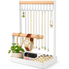 a white jewelry organizer with necklaces, watch and bracelets hanging from it's sides