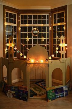 a room filled with toys and lights next to a window covered in snowflakes