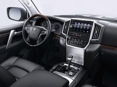 the interior of a car with black leather seats and steering wheel, center console and dashboard controls