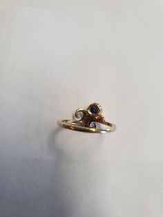 14Kt. yellow gold ring bezel set with 4mm round blue sapphire. Stone is a very nice medium blue shade. Size 5 1/4. Designed and handcrafted by Richelle Leigh using the lost wax casting process. Free shipping US. https://www.etsy.com/shop/RichelleJewelry Blue Sapphire Stone, Harrisburg Pa, Ring Bezel, Swirl Ring, Wax Casting, Lost Wax Casting, September Birthstone, Sapphire Stone, Lost Wax