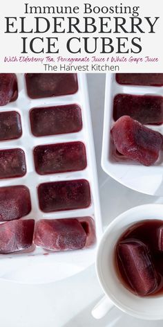 an ice cube tray filled with red liquid next to a cup of tea