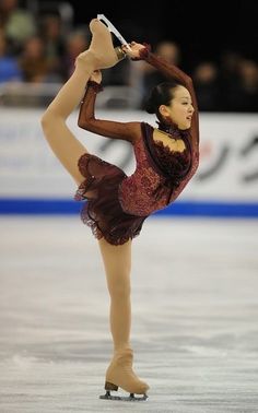 a female figure skating on an ice rink