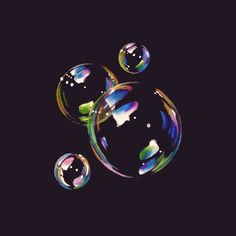 soap bubbles floating in the air on a black background