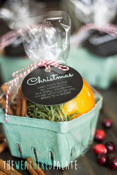 a basket filled with cinnamons and oranges next to other holiday treats on a table