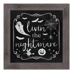 a chalkboard sign that says livn't the nightmare with bats and pumpkins