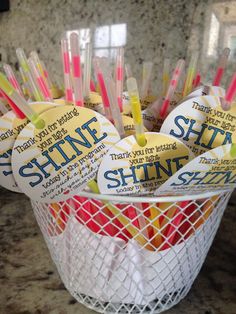 several toothbrushes in a white basket with tags on them that say, shine