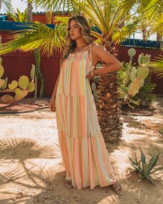 Relaxed Fit Self & Lining¨C 100% Polyester Hand Wash Cold. Dry Flat Maxi Length Scoop Neckline Flowy Body Smocked Chest and Upper Back Adjustable Shoulder Tie Closure Fully Lined Our Copeland Smocked Tiered Tassel Maxi Dress will inspire you to take a vacay! Yellow. mint. salmon. and peach stripes make up this tiered maxi. Finished with adjustable tassel tie straps. Styled with the Emperor Coin Necklace and Brianne Twisted Faux Leather Sandal.---SIZE AND FIT---Model is Wearing a Size Medium. Beach Multicolor Maxi Dress With Smocked Back, Multicolor Smocked Dress For Summer Beach, Pink Maxi Length Smocked Dress For Beach, Pink Smocked Maxi Dress For Beach, Pink Maxi Smocked Dress For Beach, Pink Maxi Length Smocked Dress For Vacation, Pink Smocked Maxi Dress For Vacation, Pink Maxi Smocked Dress For Vacation, Multicolor Smocked Sundress For Beach