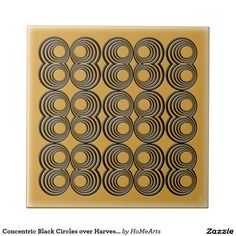 an art deco tile with circles in black and gold on a white background, the design is