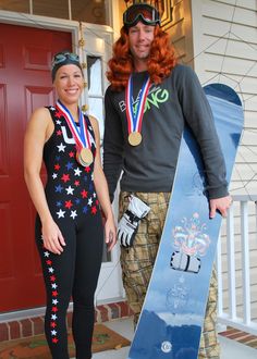 the man and woman are posing with their snowboards