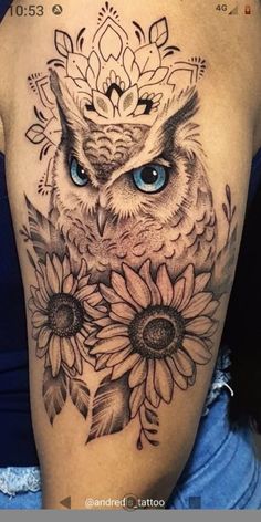 an owl with blue eyes and sunflowers on the side of a woman's arm