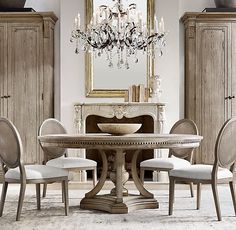 a dining room table with chairs and a chandelier