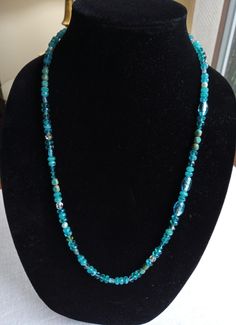 Long glass bead necklace in shades of aqua and turquoise with clear bead mixed in that give it a wonderful sparkle! At 24 in. long it is a great accent piece. Closes with a silver tone hook. Turquoise Long Necklace With Faceted Beads, Long Turquoise Necklace With Faceted Beads, Turquoise Beaded Long Crystal Necklace, Turquoise Beaded Necklaces With Gemstone Beads, Turquoise Aquamarine Beaded Necklace, Turquoise Aquamarine Gemstone Beads Necklace, Turquoise Beaded Glass Jewelry, Turquoise Beaded Czech Glass Necklace, Turquoise Czech Glass Beaded Necklace For Gift