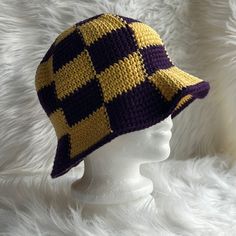 a crocheted hat is shown on a mannequin head