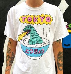 "High quality heavy cotton T-shirt. Designed by London based illustrator Gabriel Hollington. Model in the photo is 6\"1 and wearing a size L." Unisex Aesthetic, Illustration Design Graphique, Vintage Pop, Shirt Design Inspiration, Cartoon Dinosaur, Tokyo Fashion, Design Graphique, Dinosaur Print, Tee Design