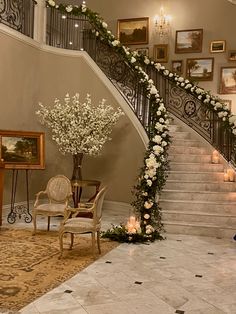 an elegant staircase decorated with flowers and candles