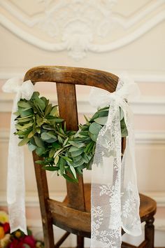 a wooden chair with a wreath on it