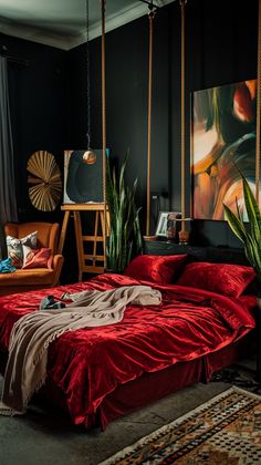 a bedroom with black walls and red bedspread on the bed is decorated with plants