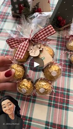 a person holding some chocolates in front of a table with christmas decorations on it