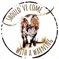 a brown and white cow standing in front of a sign that says, should't we come with a warning?