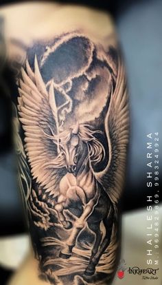 a man's arm with a black and grey tattoo on it, depicting an angel riding a horse